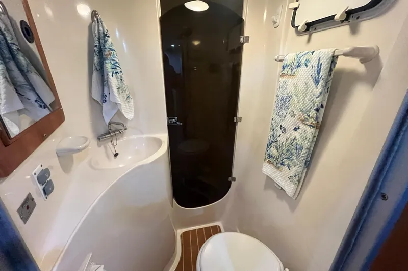  Yacht Photos Pics Compact bathroom in 2004 PDQ Passage Maker boat with sink, toilet, and shower.