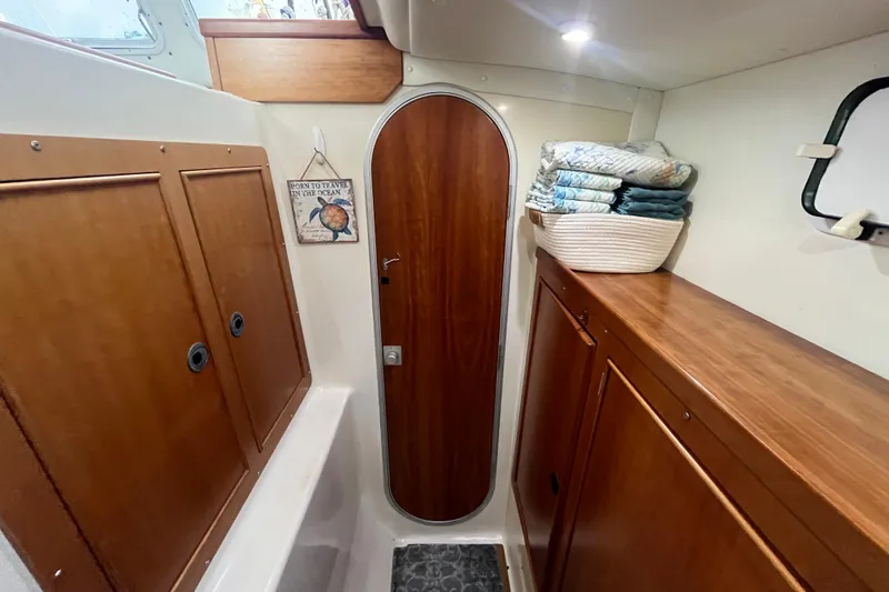  Yacht Photos Pics Interior of 2004 PDQ Passage Maker boat with wooden cabinets and a cozy atmosphere.
