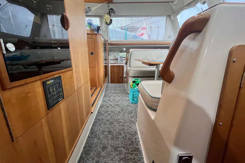  Yacht Photos Pics Interior of 2004 PDQ Passage Maker yacht with wood paneling and seating area.