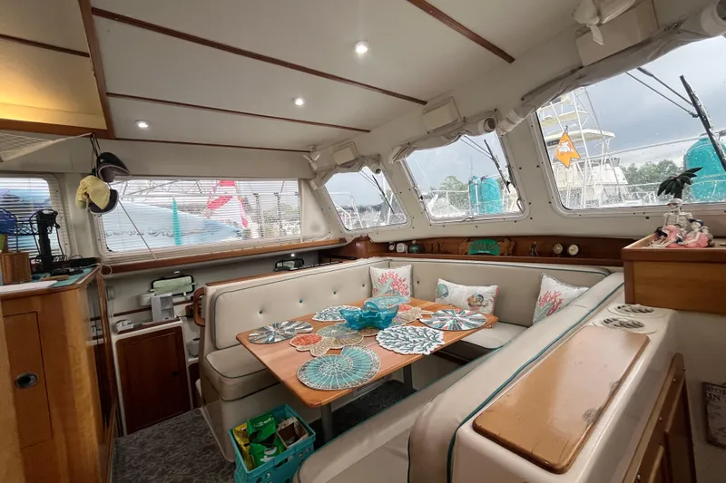  Yacht Photos Pics Cozy interior of 2004 PDQ Passage Maker yacht with dining area and nautical decor.