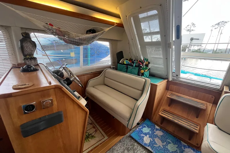 Yacht Photos Pics Interior of 2004 PDQ Passage Maker boat with helm, seating, and nautical decor.