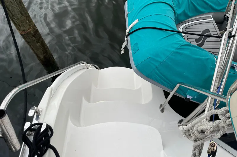  Yacht Photos Pics Stern view of 2004 PDQ Passage Maker with turquoise dinghy and dock ropes.