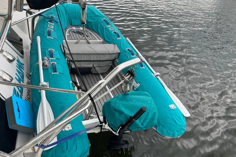  Yacht Photos Pics Inflatable boat attached to PDQ Passage Maker 2004, floating on calm water.