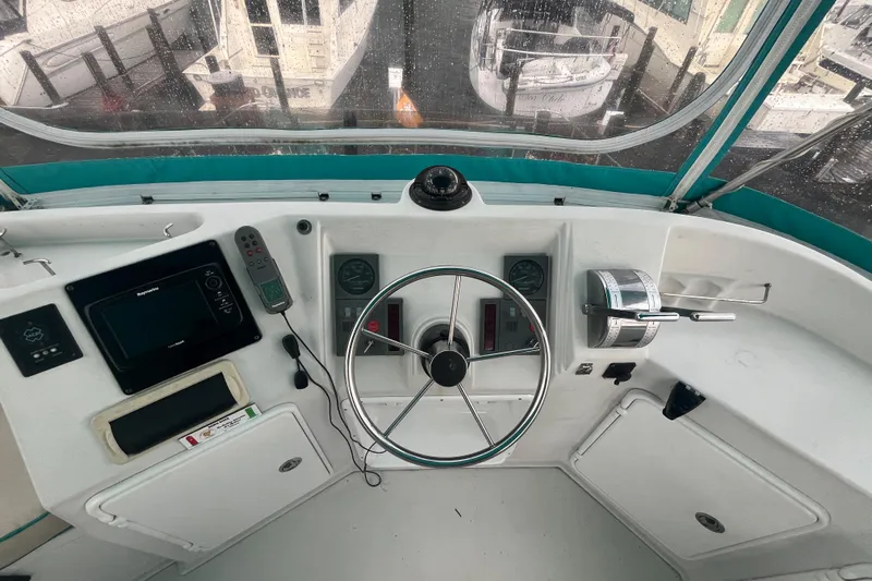  Yacht Photos Pics 2004 PDQ Passage Maker helm with steering wheel, controls, and navigation equipment.