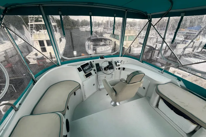  Yacht Photos Pics Helm of 2004 PDQ Passage Maker boat with cushioned seating and marina view.