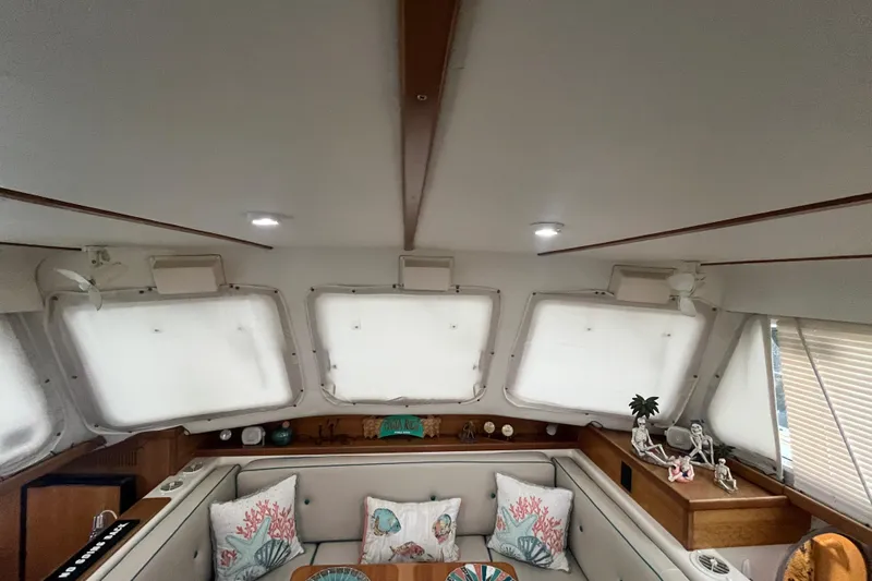  Yacht Photos Pics Interior of 2004 PDQ Passage Maker yacht with cozy seating and nautical decor.