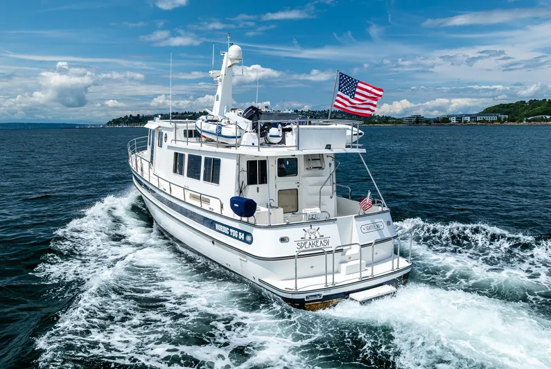 Speakeasy Yacht Photos Pics 2007 Nordic Tug 54 cruising on open water under a clear blue sky.