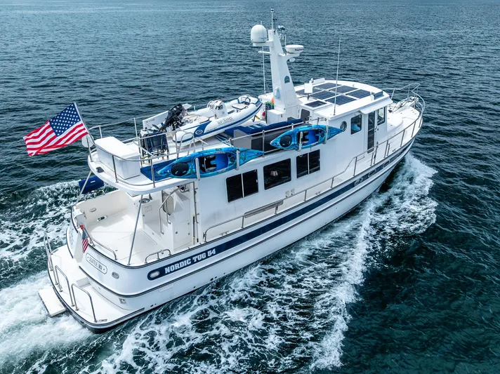 Speakeasy Yacht Photos Pics 2007 Nordic Tug 54 cruising on open water with American flag.