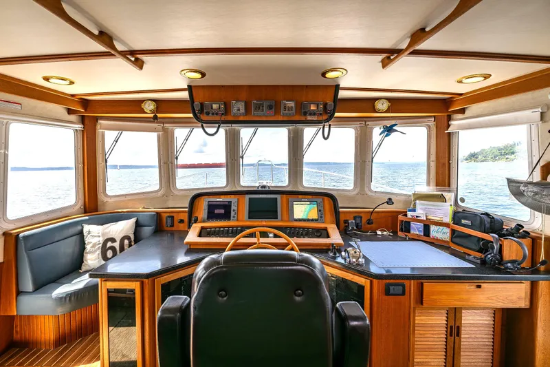 Speakeasy Yacht Photos Pics Pilothouse of 2007 Nordic Tug 54 with navigation equipment and panoramic sea view.