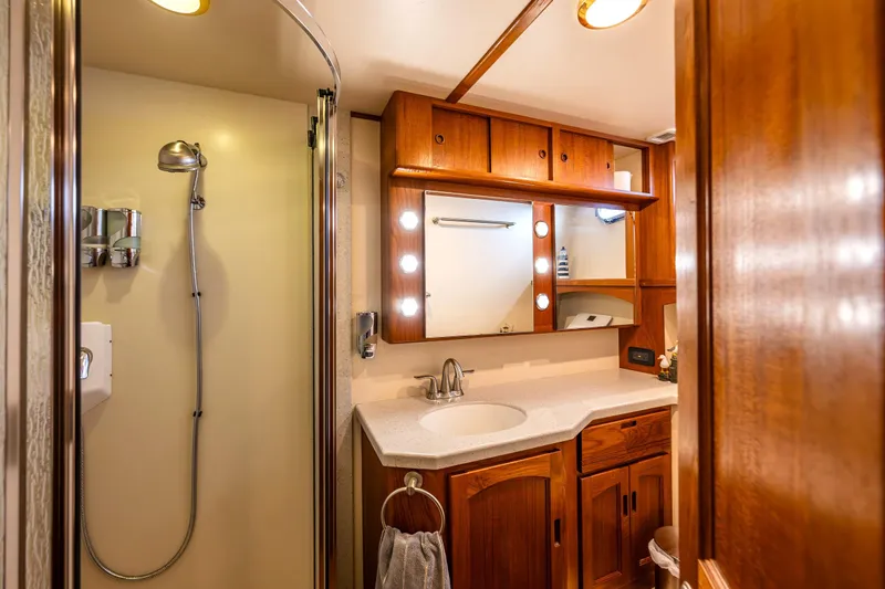 Speakeasy Yacht Photos Pics Luxurious 2007 Nordic Tug 54 bathroom with wooden cabinetry and modern shower.