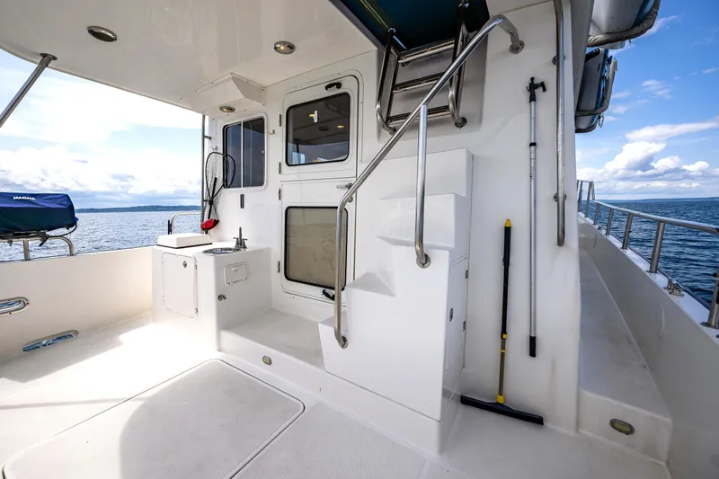 Speakeasy Yacht Photos Pics Nordic Tug 54 yacht deck, 2007 model, featuring outdoor sink and ocean view.