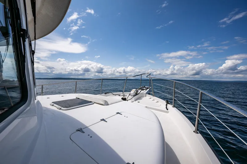 Speakeasy Yacht Photos Pics 2007 Nordic Tug 54 yacht deck with ocean view under blue sky.