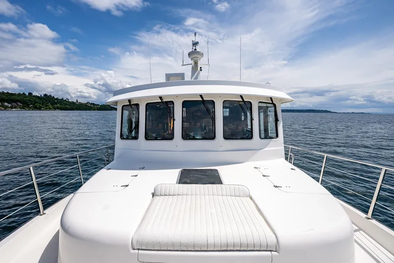 Speakeasy Yacht Photos Pics 2007 Nordic Tug 54 yacht on open water under a partly cloudy sky.
