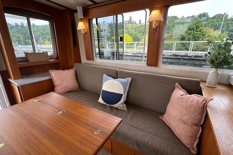 Speakeasy Yacht Photos Pics Cozy interior of 2007 Nordic Tug 54 with plush seating and decorative pillows.