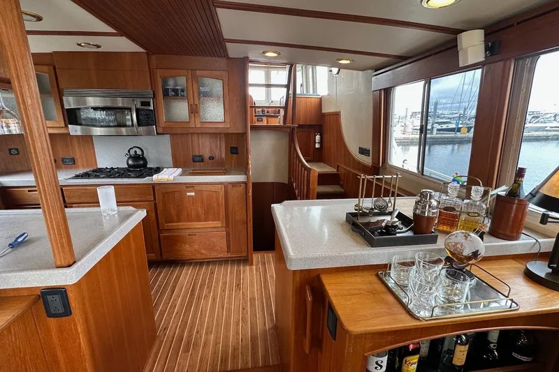 Speakeasy Yacht Photos Pics Luxurious 2007 Nordic Tug 54 interior with wooden cabinetry and modern kitchen amenities.