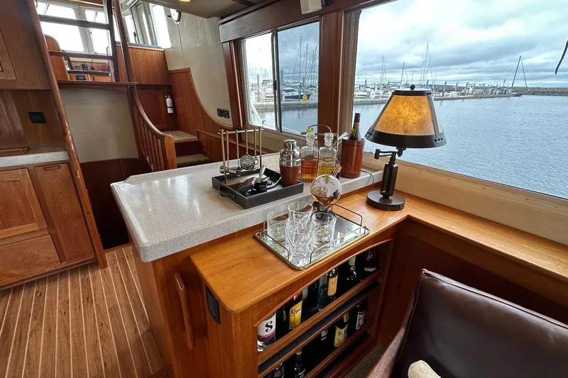 Speakeasy Yacht Photos Pics Luxurious interior of 2007 Nordic Tug 54 yacht with bar and scenic marina view.