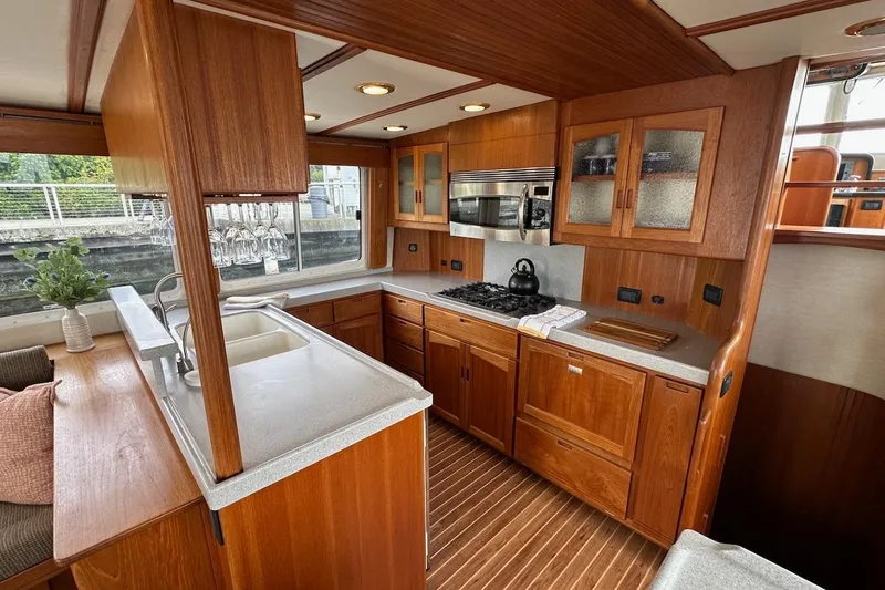 Speakeasy Yacht Photos Pics Luxurious 2007 Nordic Tug 54 kitchen with wood cabinetry and modern appliances.