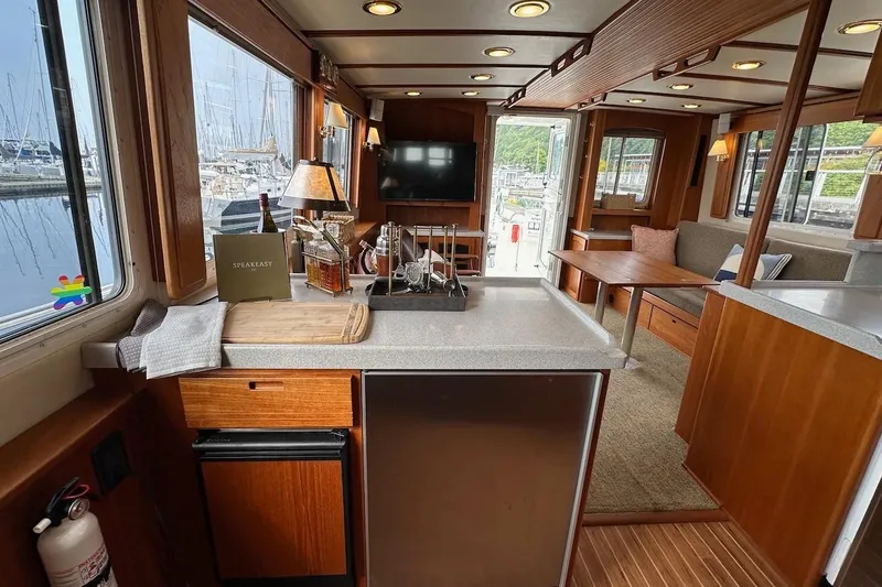 Speakeasy Yacht Photos Pics Interior of a 2007 Nordic Tug 54 yacht with modern kitchen and cozy seating area.