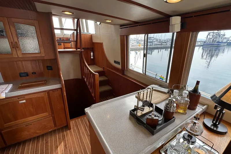 Speakeasy Yacht Photos Pics Interior of 2007 Nordic Tug 54 yacht with wooden cabinetry and bar setup.