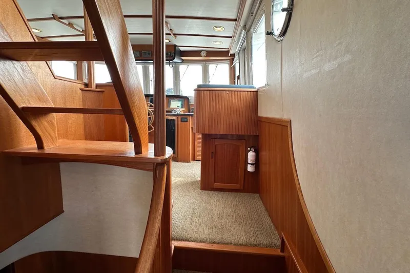 Speakeasy Yacht Photos Pics Interior of 2007 Nordic Tug 54, featuring wooden stairs and helm area.