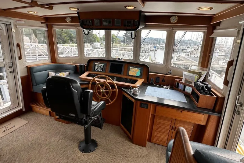 Speakeasy Yacht Photos Pics Pilothouse of 2007 Nordic Tug 54 with navigation equipment and panoramic windows.