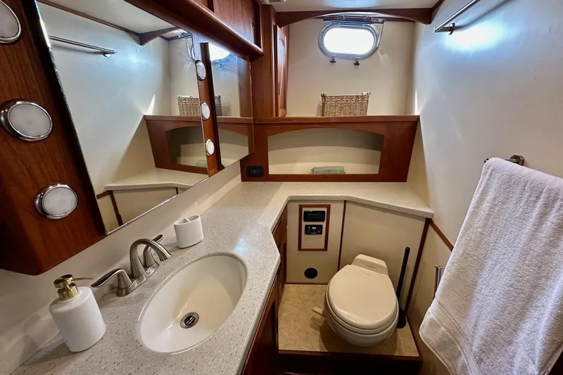 Speakeasy Yacht Photos Pics Luxurious bathroom in 2007 Nordic Tug 54 yacht with modern fixtures and elegant wood accents.