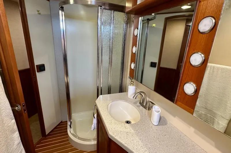 Speakeasy Yacht Photos Pics Luxurious bathroom in 2007 Nordic Tug 54 yacht with shower and elegant wood accents.