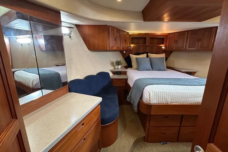 Speakeasy Yacht Photos Pics Luxurious 2007 Nordic Tug 54 bedroom with elegant wood cabinetry and cozy bedding.