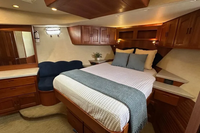 Speakeasy Yacht Photos Pics Luxurious cabin interior of a 2007 Nordic Tug 54 with cozy bed and wooden cabinetry.
