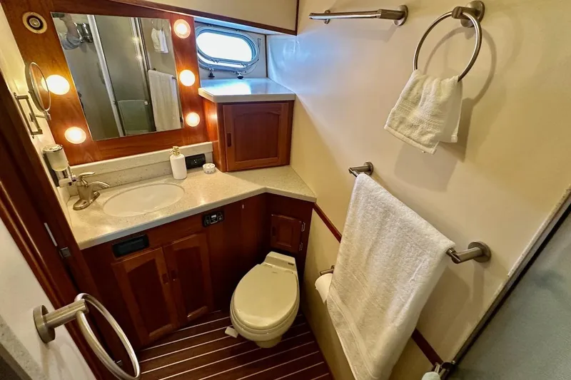 Speakeasy Yacht Photos Pics Luxurious bathroom in 2007 Nordic Tug 54 yacht with wood accents and modern fixtures.