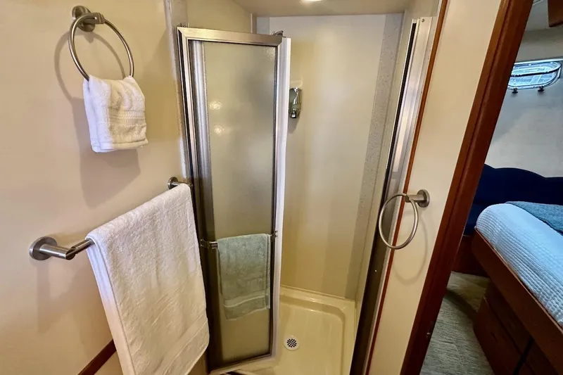 Speakeasy Yacht Photos Pics Compact bathroom with shower in 2007 Nordic Tug 54 yacht, featuring towel racks and modern design.