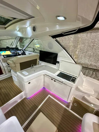 Sand Bar Yacht Photos Pics 2011 Sea Ray 450 Sundancer interior with modern helm, seating, and ambient lighting.