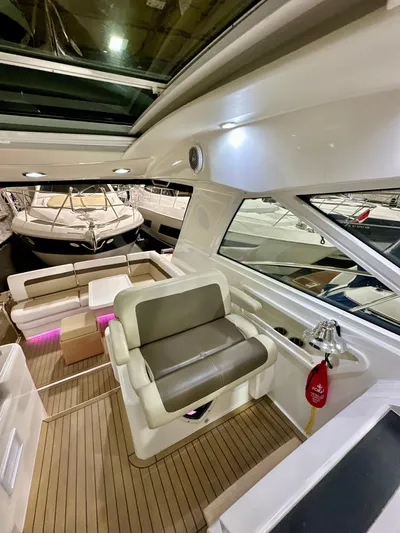 Sand Bar Yacht Photos Pics Interior of 2011 Sea Ray 450 Sundancer yacht with modern seating and wood flooring.