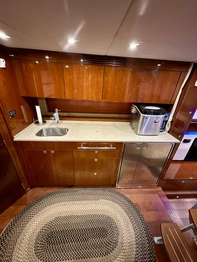 Sand Bar Yacht Photos Pics Luxurious kitchen area in a 2011 Sea Ray 450 Sundancer yacht with modern amenities.