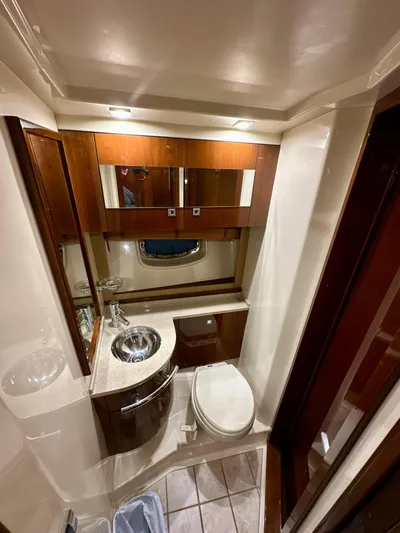 Sand Bar Yacht Photos Pics Luxurious bathroom in 2011 Sea Ray 450 Sundancer yacht with modern fixtures and wood accents.