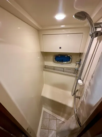 Sand Bar Yacht Photos Pics 2011 Sea Ray 450 Sundancer shower area with modern fixtures and porthole window.
