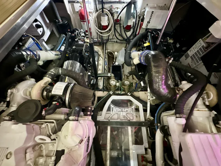 Sand Bar Yacht Photos Pics Engine room of a 2011 Sea Ray 450 Sundancer yacht, showcasing mechanical components.