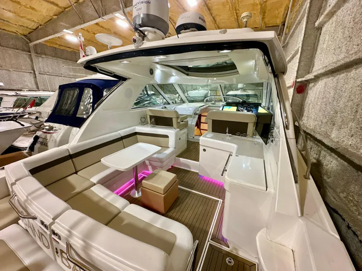 Sand Bar Yacht Photos Pics 2011 Sea Ray 450 Sundancer yacht interior with seating and ambient lighting in a storage facility.