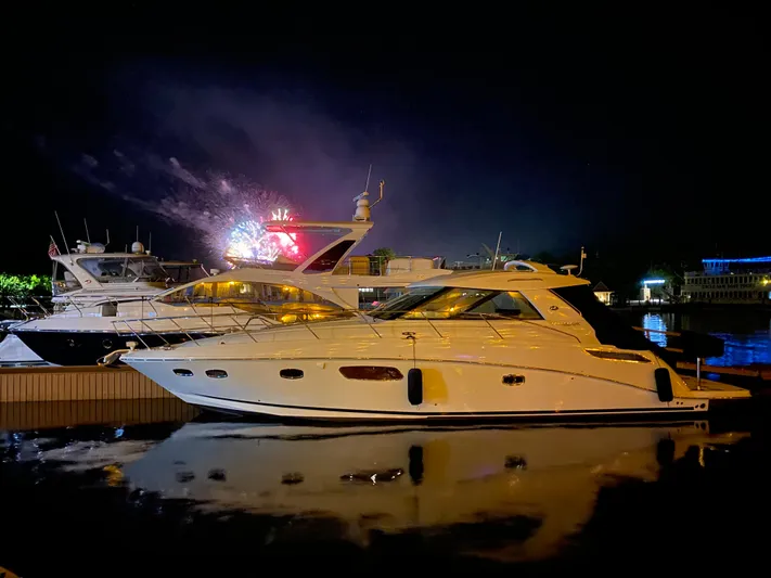 Sand Bar Yacht Photos Pics 2011 Sea Ray 450 Sundancer yacht docked at night with fireworks in the background.