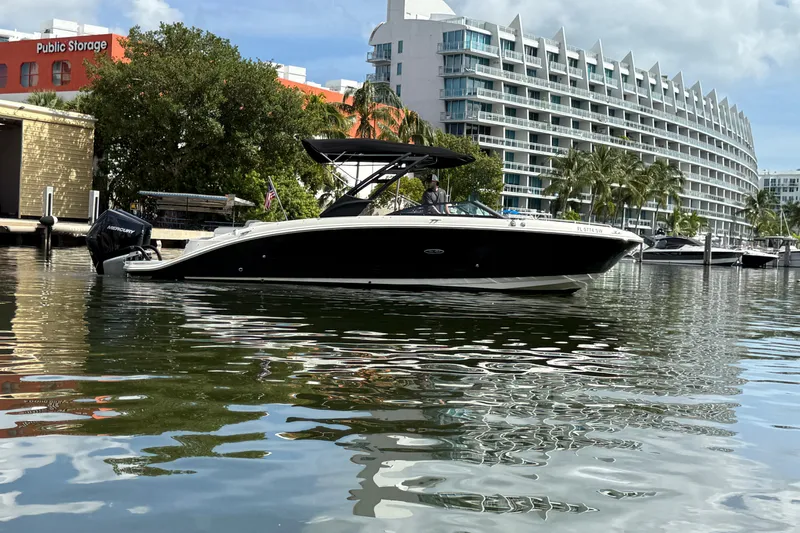  Yacht Photos Pics 2021 Sea Ray SDX 290 Outboard boat docked near modern waterfront buildings.