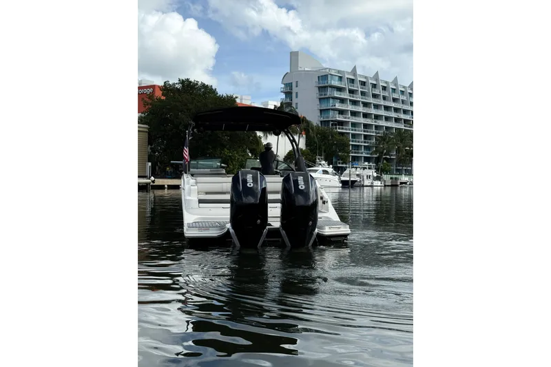  Yacht Photos Pics 2021 Sea Ray SDX 290 Outboard boat on water near modern buildings.
