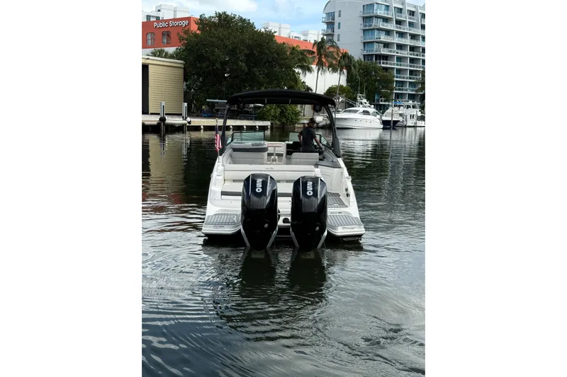  Yacht Photos Pics 2021 Sea Ray SDX 290 Outboard boat on water near urban marina.