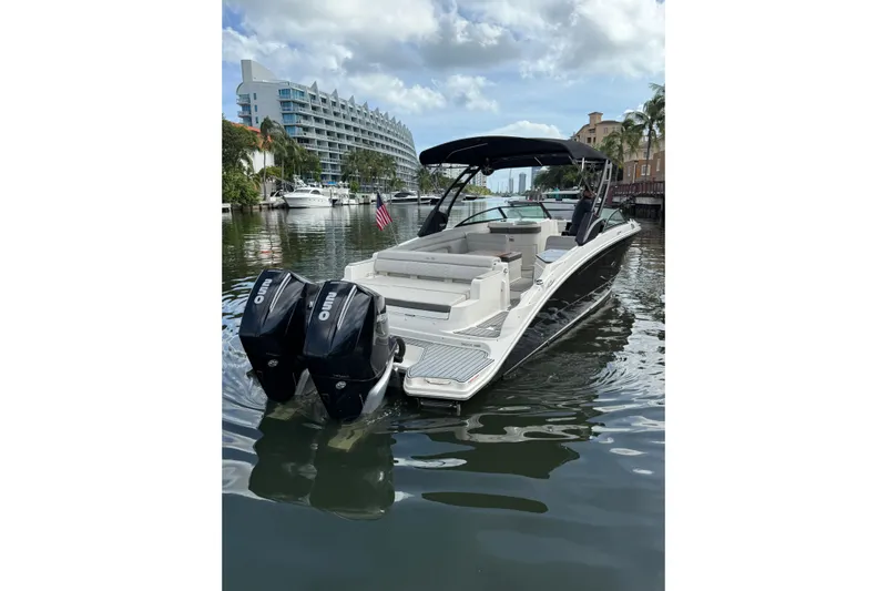  Yacht Photos Pics 2021 Sea Ray SDX 290 Outboard boat on a calm waterway, featuring dual engines.