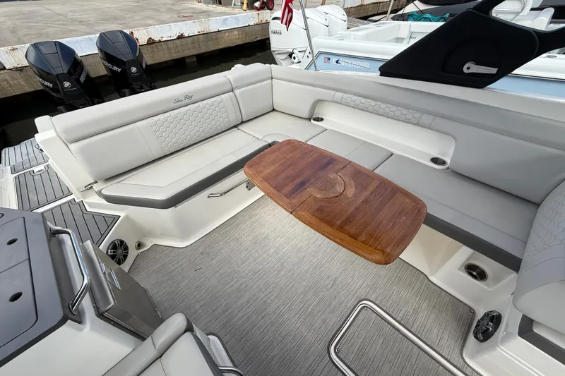  Yacht Photos Pics 2021 Sea Ray SDX 290 Outboard interior with elegant seating and wooden table.