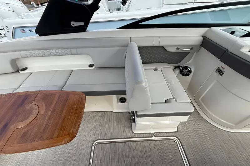  Yacht Photos Pics 2021 Sea Ray SDX 290 Outboard interior with sleek seating and wooden table.