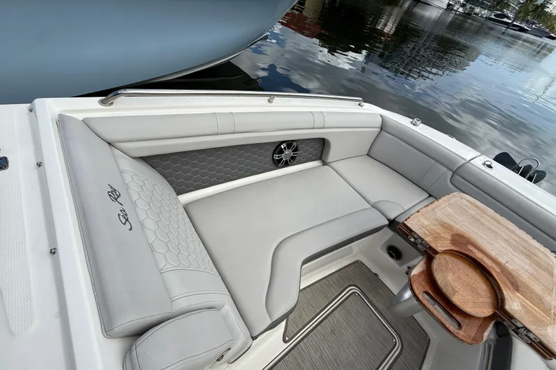  Yacht Photos Pics 2021 Sea Ray SDX 290 Outboard boat interior with elegant seating and wooden table.