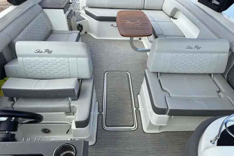  Yacht Photos Pics Luxurious interior of 2021 Sea Ray SDX 290 Outboard with elegant seating and table.