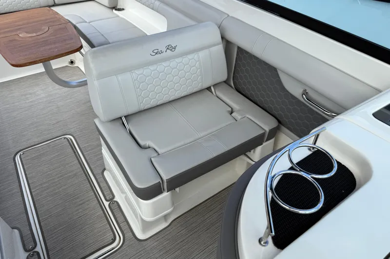  Yacht Photos Pics 2021 Sea Ray SDX 290 Outboard interior with gray seating and wooden table.