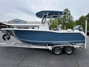 2025 Tidewater 232 LXF boat on trailer, parked outdoors near dealership.