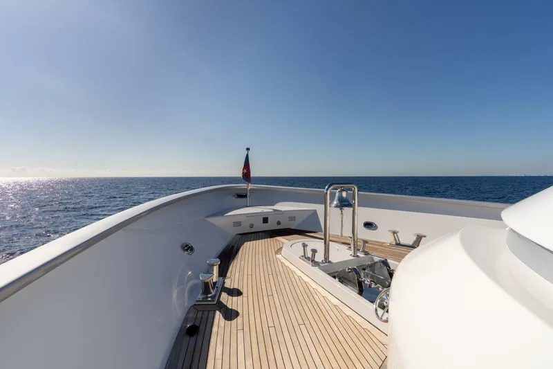 Ruffian Yacht Photos Pics Luxurious 2001 Delta Marine Tri-Deck yacht deck with ocean view and clear blue sky.